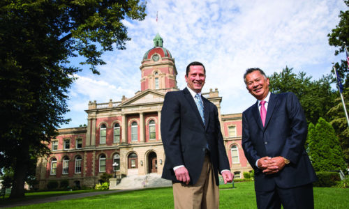 Pete McCown and Dzung Nguyen standing in front of the County Courthouse